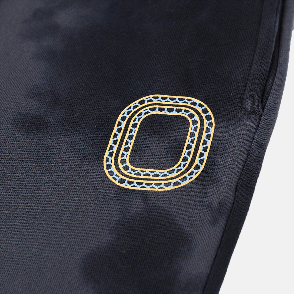 Up close view of emblem on the Overtime Kids' Aura Dye Jogger.