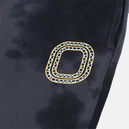 Up close view of emblem on the Overtime Kids' Aura Dye Jogger.